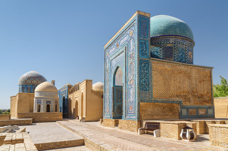 Awesome view of the Shah-i-Zinda Ensemble in Samarkand, Uzbekistan. Mausoleums decorated by blue tiles with designs. The necropolis is a popular tourist attraction of Central Asia.の写真素材