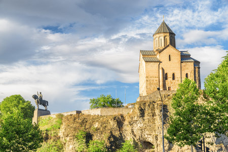 Awesome view of the Virgin Mary Assumption Church of Metekhi on the cliff over the Kura (Mtkvari) River in Tbilisi, Georgia. The Georgian Orthodox Christian church is a popular tourist attraction.の写真素材