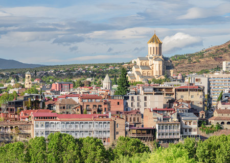 Awesome city view of Tbilisi, Georgia. The Holy Trinity Cathedral of Tbilisi (Sameba) is visible on...