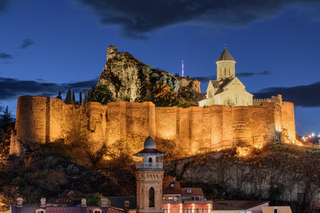 Awesome night view of Narikala Fortress with Saint Nicholas Orthodox Church in Old Town of Tbilisi, Georgia. The ancient fortress is a popular tourist attraction of the Caucasus region.の写真素材