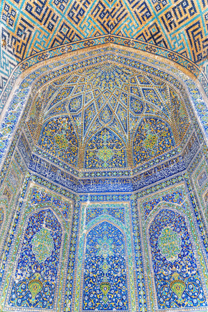Samarkand, Uzbekistan - September 4, 2022: Colorful arched niches at courtyard of the Sher-Dor Madrasah at the Registan Square in Samarkand. The Registan is a popular tourist attraction of Asia.のeditorial素材