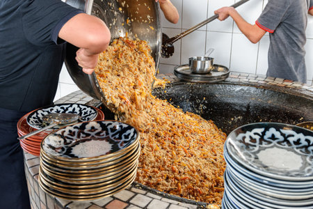 Fresh cooked wedding Uzbek plov in Tashkent, Uzbekistan. The signature dish of Uzbekistan is cooked with rice, meat, carrots and onions. Pilaf is a traditional food at Central Asia.の写真素材