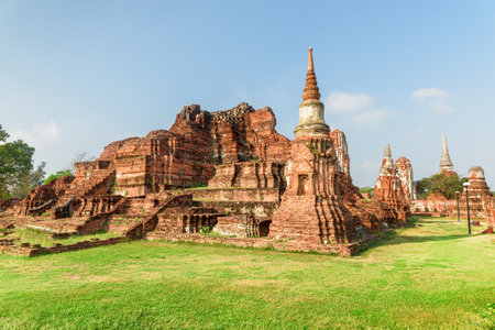 Scenic ruins of the Wat Mahathat in Ayutthaya, Thailand. Amazing view of the Buddhist temple in the ancient city and capital of the Ayutthaya Kingdom or Siam. Thailand is a popular tourist destinationの写真素材