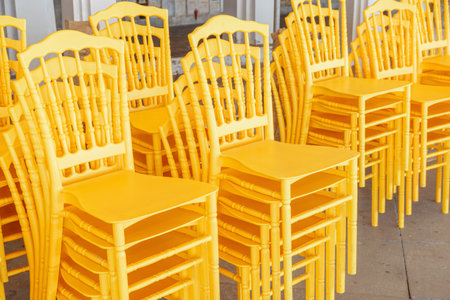 Yellow chairs for pilgrims at Wat Arun in Bangkok, Thailand. The Buddhist temple is a landmark of Bangkok and a popular tourist attraction of Thailand.の写真素材