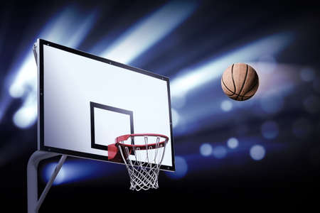 Basket ball heading the hoop with spotlightsの写真素材