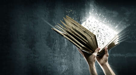 Opened magic book with magic lightsの写真素材