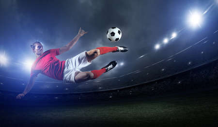 Soccer player in action on stadium background.The imaginary soccer stadium is modeled and rendered.