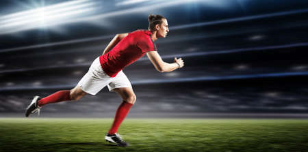 Soccer player running in the stadium.The imaginary stadium is modelled and rendered.の写真素材