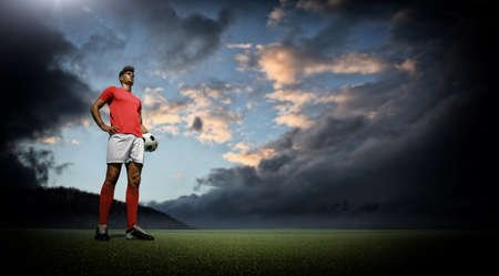 Football player and dark cloudsの写真素材