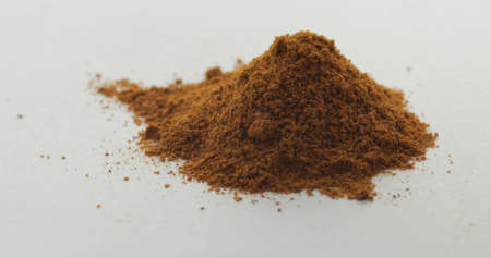 Red pepper powder. Red herbal spice, aromatic seasoning for food preparation and cooking, macro shot against a white backgroundの写真素材