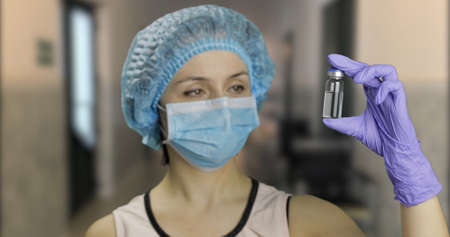 Female scientist holding ampoule in hand in hospital, new medication developing, vaccination. Concept of medicine and health improvement. Chroma key background. Green screenの写真素材