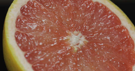 Delicious grapefruit cut for squeezing fresh juice, citrus fruit in healthy menu. Vitamin C source, citric acid nutrition, lowering cholesterol level, antioxidantの写真素材