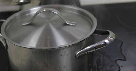 Boiling Water In The Pan that is covered with a lid in the kitchen.