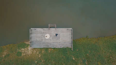 Groom with bride near lake in the park. Groom walk to bride. Wedding couple. Aerial shot