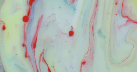 Abstract psychedelic background. Ink in a multicolored liquid. Colorful paint drops mixing in water....