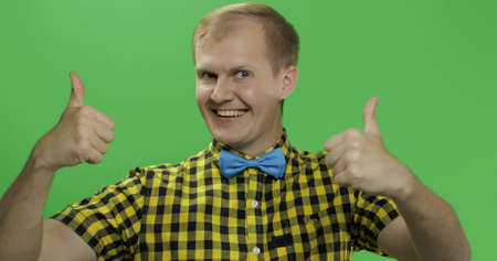 Caucasian fashionable man show thumbs up. Guy in yellow shirt. Chroma key. Few shotsの写真素材