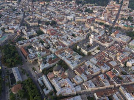 Aerial roofs and streets Old City Lviv, Ukraine. Central part of old european city in morning. Panorama of the ancient town. City Council, Town Hall, old Dominican Church. Drone shotの写真素材
