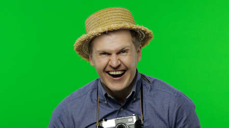 Portrait of man fashion tourist photographer laughs very loudly. Handsome man on vacation in blue...