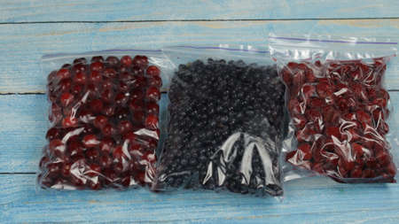 Close up shot of packages with berries in zipper plastic bags for freezing. Frosting, icing, freeze...