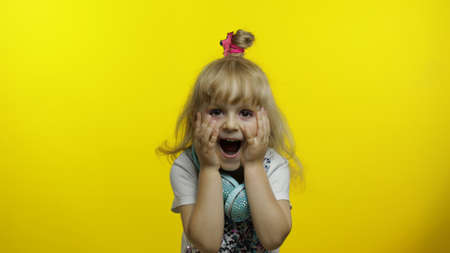 Stylish child show amazement, fooling around, smiling, looking surprised shocked, open mouth. Little...