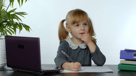 Back to school, online learning for kids, distance lesson, education at home, technology for schoolgirl, conference. Children doing homework at home. Child girl on white backgroundの写真素材