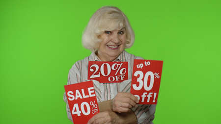Grandma showing sale percent discounts advertisement inscriptions banners. Grandmother rejoicing...