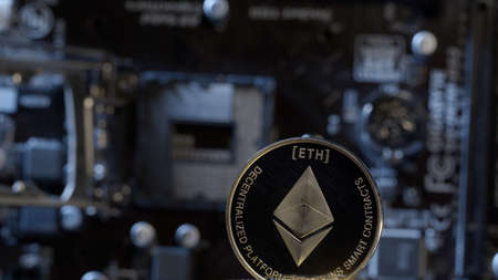 Cryptocurrency mining. Ethereum coin on computer motherboard background. Concept of finance trading,...