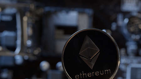 Cryptocurrency mining. Ethereum coin on digital technology pc motherboard background. Market trading cashless e-commerce. Gold coin isolated on computer board. New virtual money, blockchainの写真素材