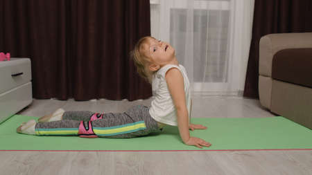 Fit little child kid training gymnastics fitness stretching workout. Healthy lifestyle, active...
