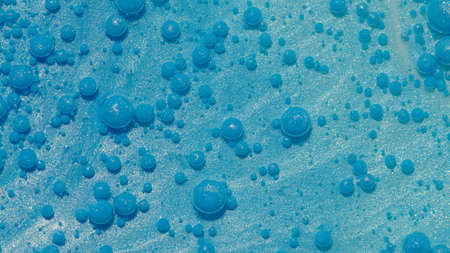 Top view fantastic structure of colorful oil paint and ink bubbles. Chaotic motion. Abstract blue...