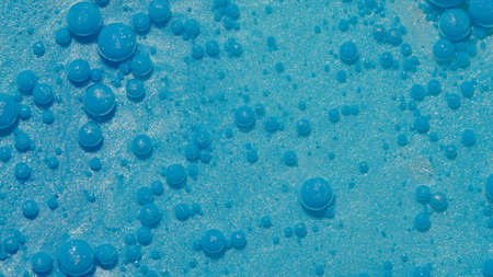 Bright neon blue bubbles oil and ink, beautiful fluorescent paint. Sparkling color multicolor moving...
