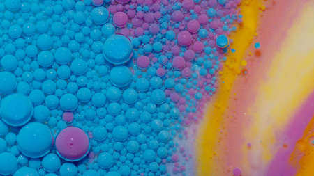 Bright neon blue bubbles oil and ink, beautiful fluorescent paint. Sparkling colorful multicolor moving close-up. Acrylic painting. Themes or wallpaper background. Abstract transformation gravitationの写真素材