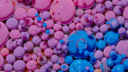 Colorful blue pink bubbles wallpaper themes background. Multicolor space universe concept. Fantastic hypnotic surface. Abstract pattern chemical reaction texture liquid paint motion bubble in waterの写真素材