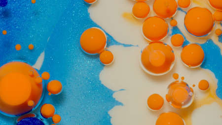 Bright ink bubbles mixed with liquid substance of oil, milk, soap. Floating acrylic paint on colorful surface. Abstract multicolor macro hypnotic transformation themes or wallpaper painting backgroundの写真素材
