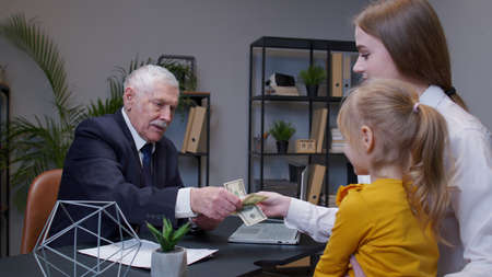 Mother and daughter child kid come to bank office to get a loan for open own business, buy housing....