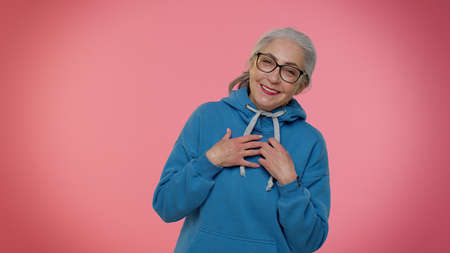 Happy joyful senior old gray-haired granny woman laughing out loud after hearing ridiculous anecdote, funny joke, feeling carefree amused, positive people lifestyle. Elderly grandmother pensionerの写真素材