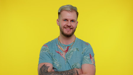 Cheerful lovely bearded adult man in fashionable t-shirt smiling and looking at camera. Young...