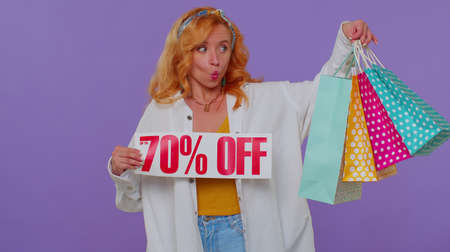 Lovely long haired girl showing shopping bags, Up To 70 Percent Off inscriptions banner text. Black...