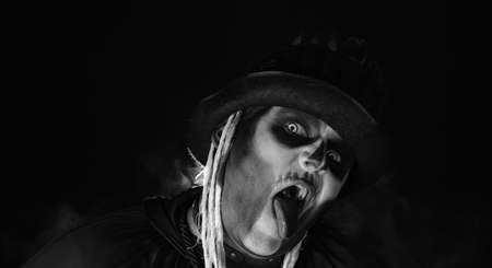 Sinister, crazy man with skeleton makeup in top-hat. Guy making angry faces, shaking head, showing...