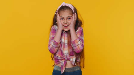 Oh my God, Wow. Young preteen child girl kid looking surprised at camera with big eyes, shocked by...