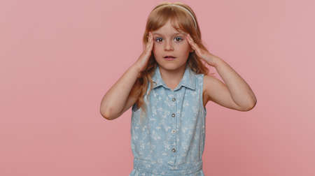 Oh my God, Wow. Young preteen child girl kid looking surprised at camera with big eyes, shocked by sudden victory, game winning lottery goal achievemen good news. Toddler children on pink backgroundの写真素材