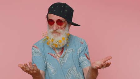 Portrait of cheerful stylish elderly man wearing sunglasses, charming smile. People emotions...
