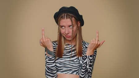 Aggressive crazy hooligan young woman showing around her middle fingers, demonstrating protest with...