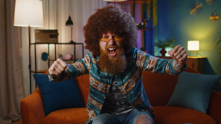 Happy bearded redhead man shouting, celebrating success, winning, goal achievement, good news...