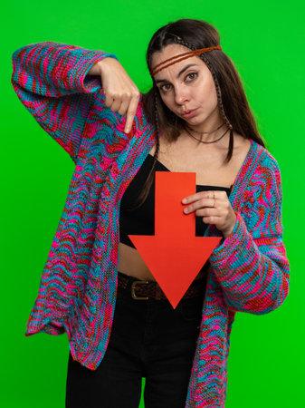 Upset woman showing red arrow pointing down, concept of downgrade, unsuccessful business, fall of stock market money exchange rate bankruptcy fail. Girl isolated on chroma key background, green screenの写真素材