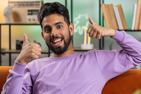 Like. Happy excited indian man looking approvingly at camera showing thumbs up, like sign positive...