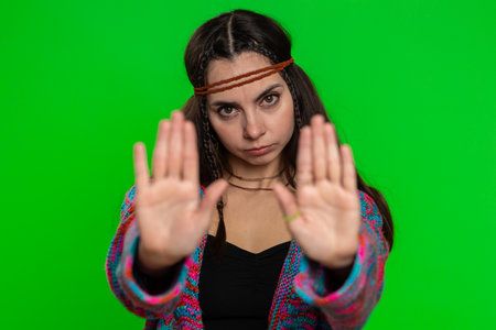 Young woman say No hold palm folded crossed hands in stop gesture, warning of finish, prohibited access, declining communication, body language, danger. Girl on chroma key background. People lifestyleの写真素材