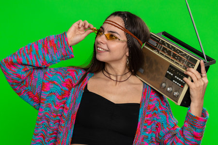 Woman in sunglasses using retro tape record player to listen music, disco dancing of favorite track,...