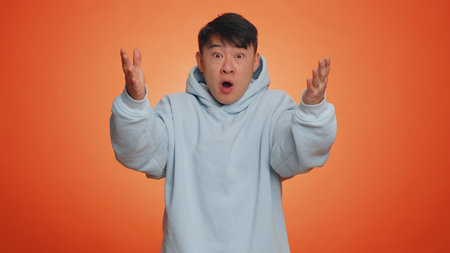Oh my God, Wow. Excited amazed winner man raising hands in surprise looking at camera with big eyes,...