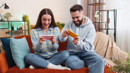 Happy family married couple man woman enthusiastically playing racing or shooter video app games...